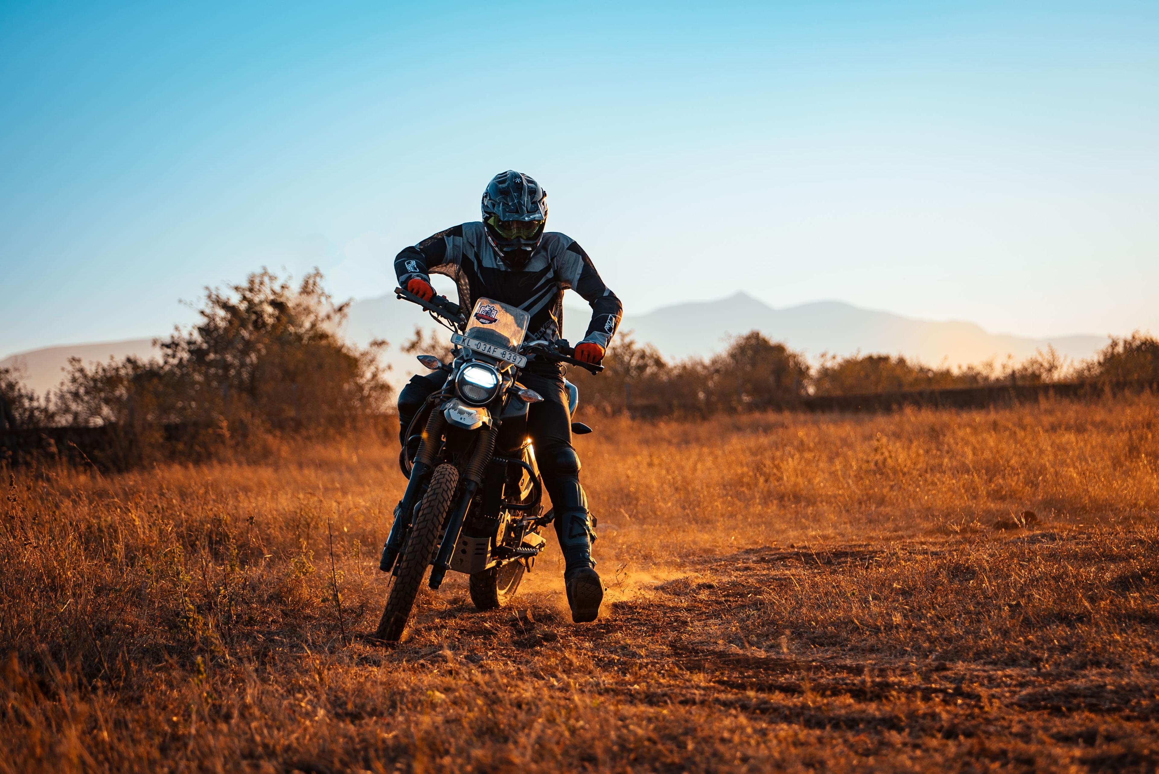 Rider leaning through a flat track corner at golden hour